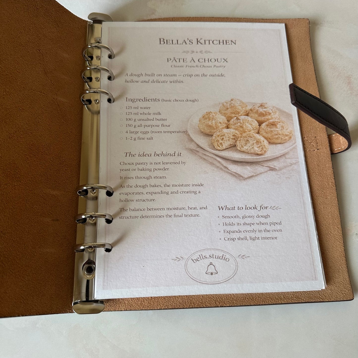 Open Bella's Kitchen Leather Binder showing organized kitchen cards inside