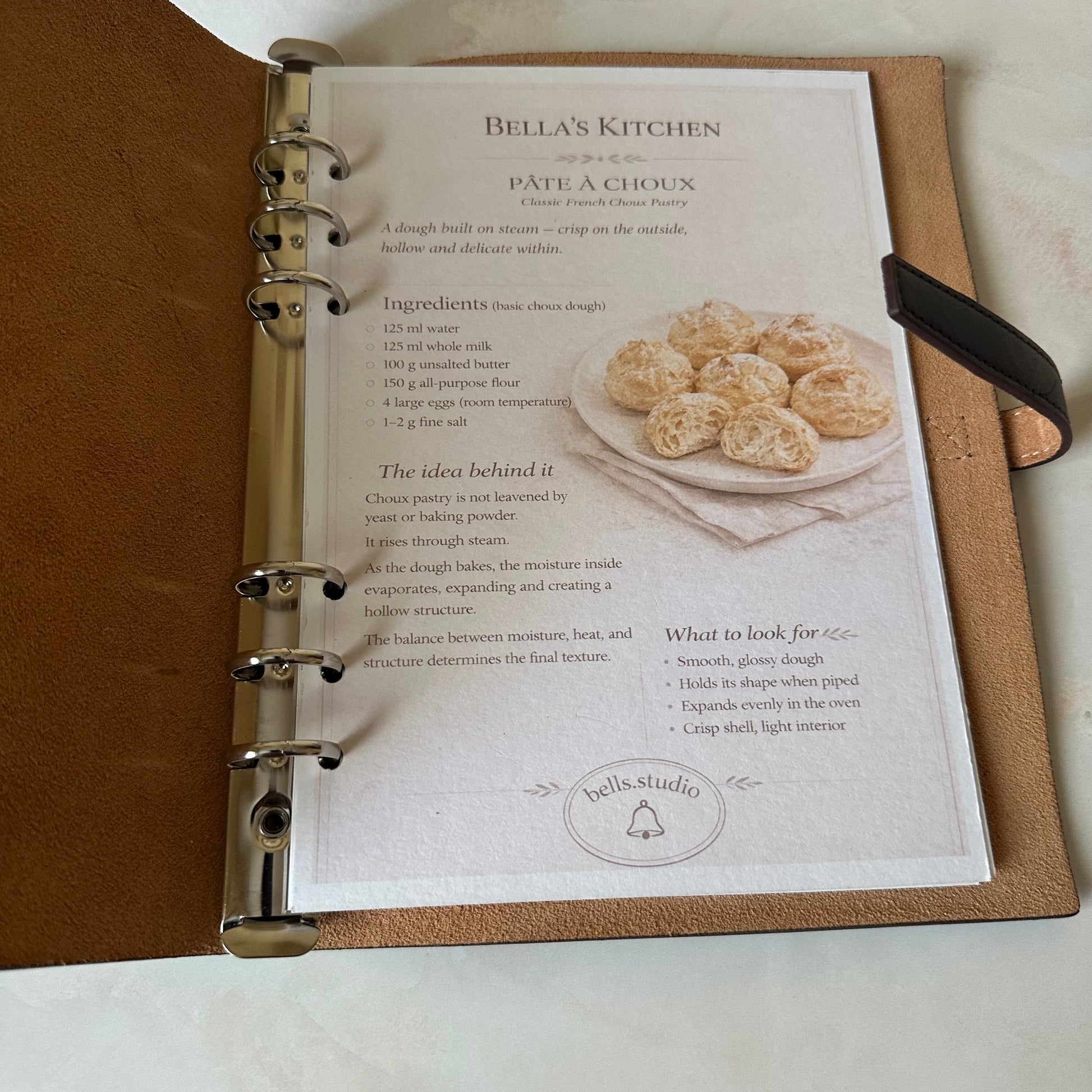 Open Bella's Kitchen Leather Binder showing organized kitchen cards inside