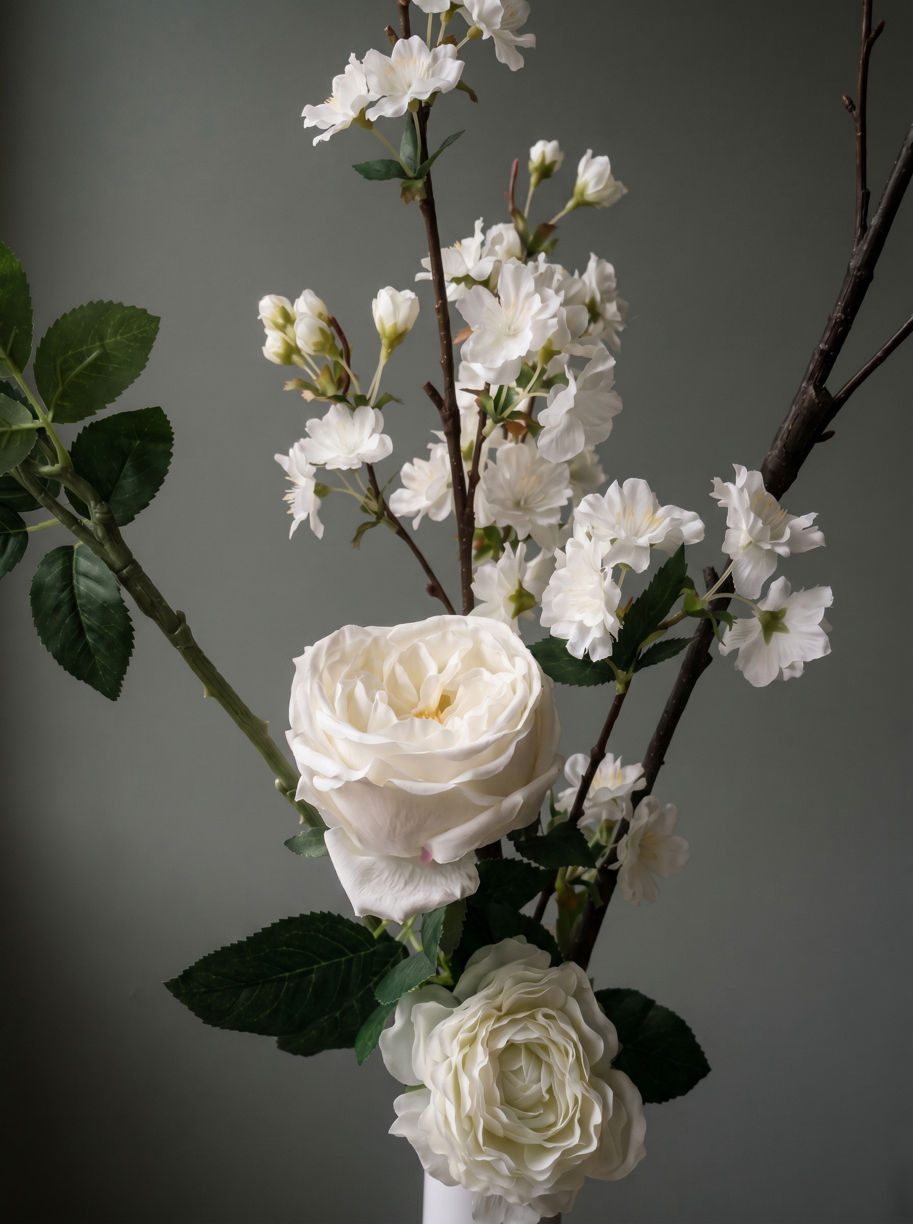 Side view of silk flower arrangement showing delicate structure and light play