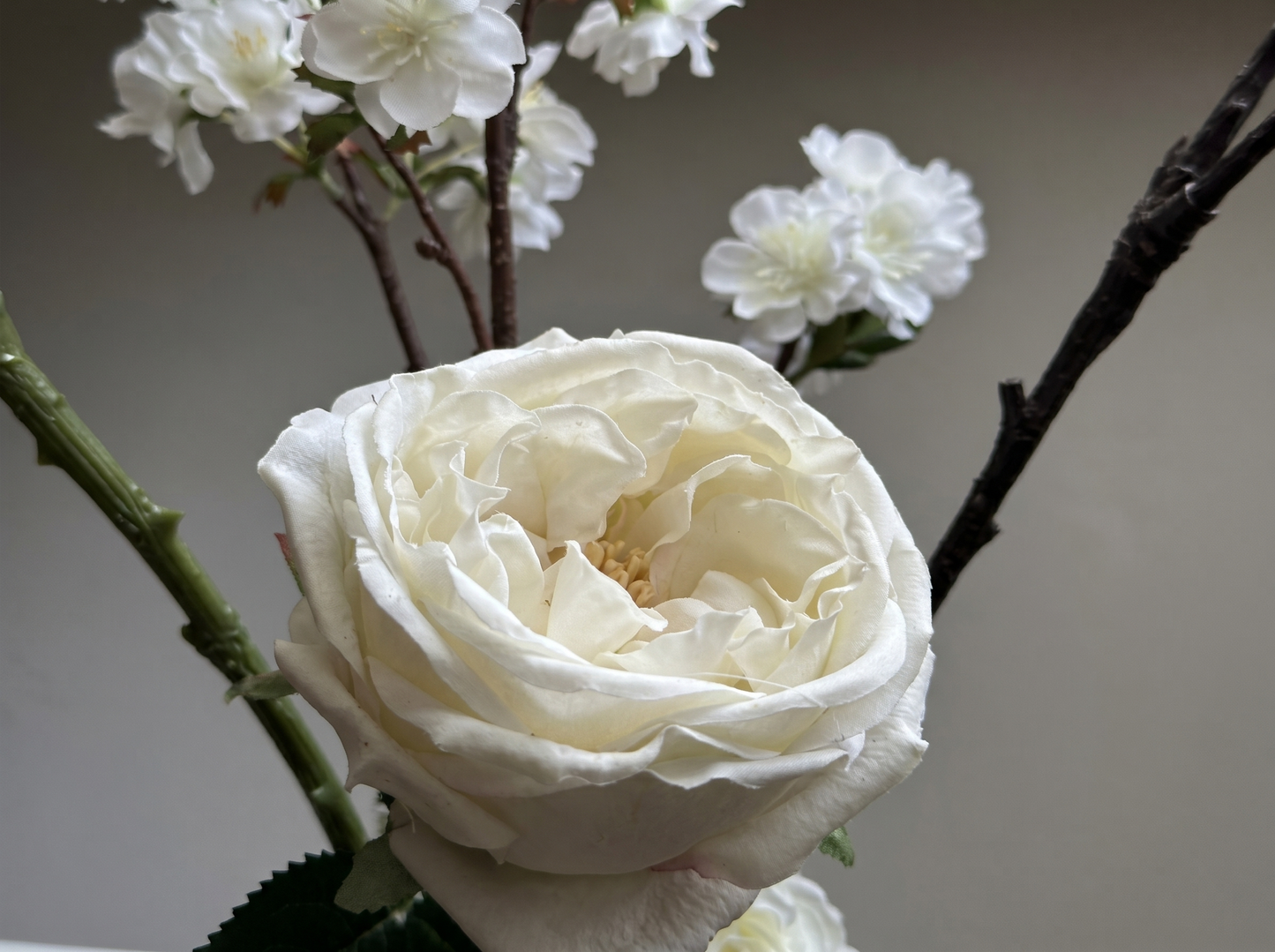 Detail of ceramic vase with white roses silk flowers