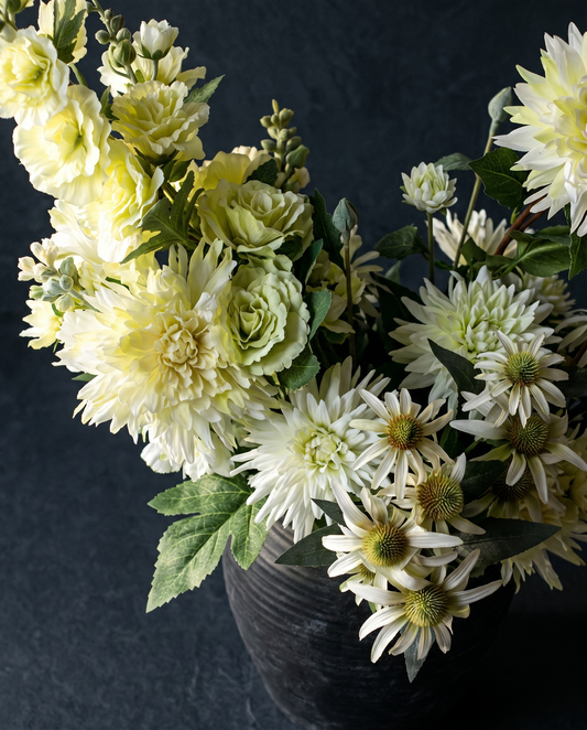 Close-up of soft yellow dahlias and echinacea in Garden Balance silk flower arrangement