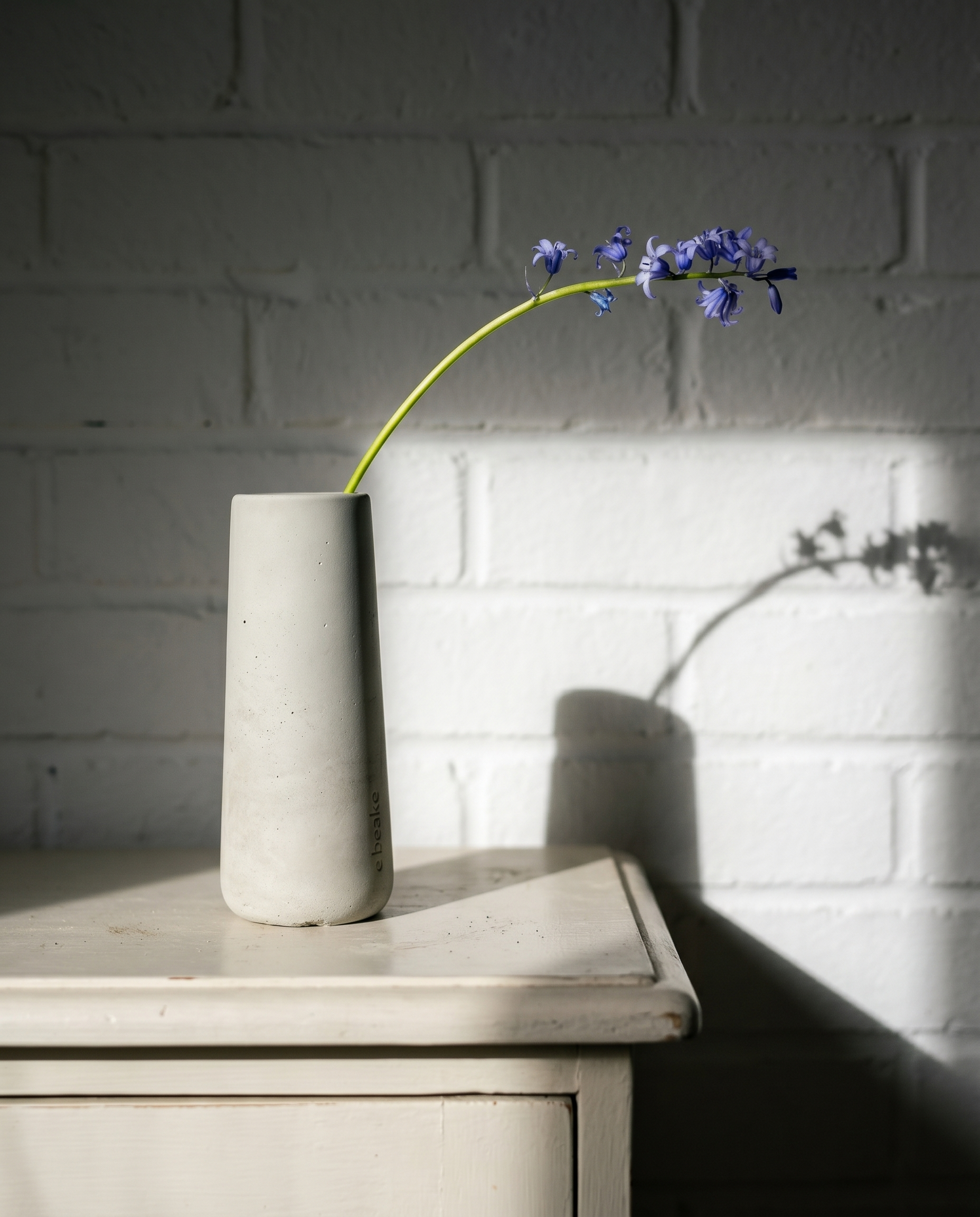 Maison Florale concrete vase paired with delicate silk flower arrangement